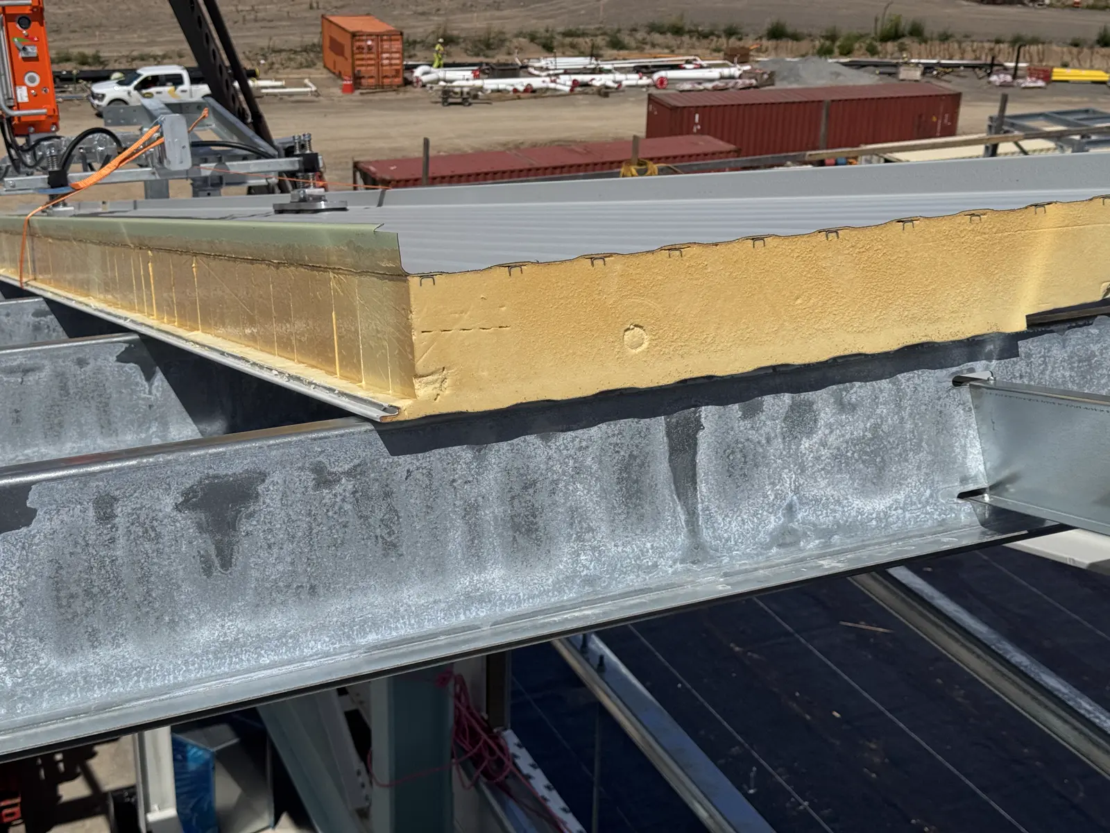 Edge of an insulated metal panel showing the insulation core and joint profile