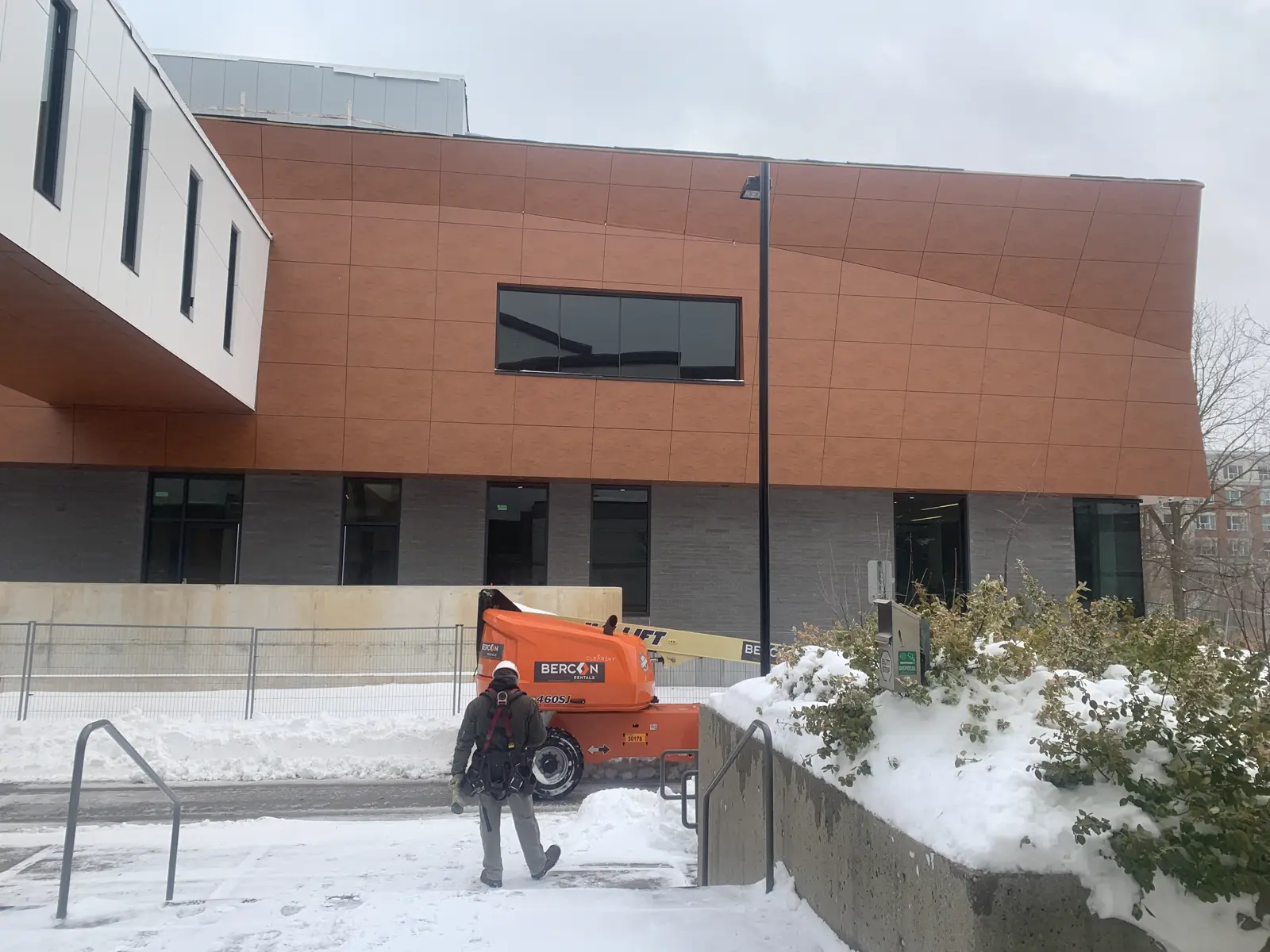 Completed architectural metal panel facade in a warm bronze finish