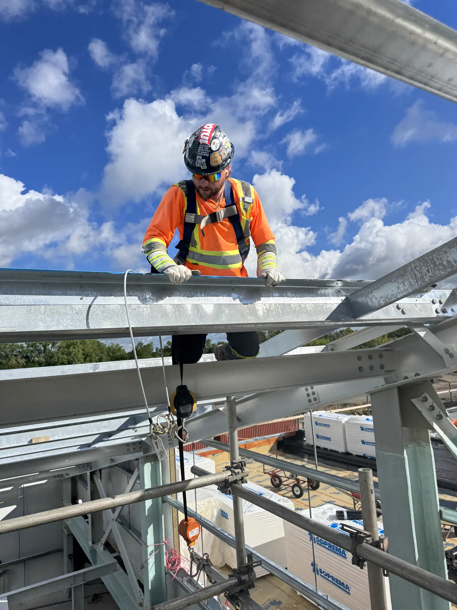 Installer tied off with fall protection while working on structural steel girts